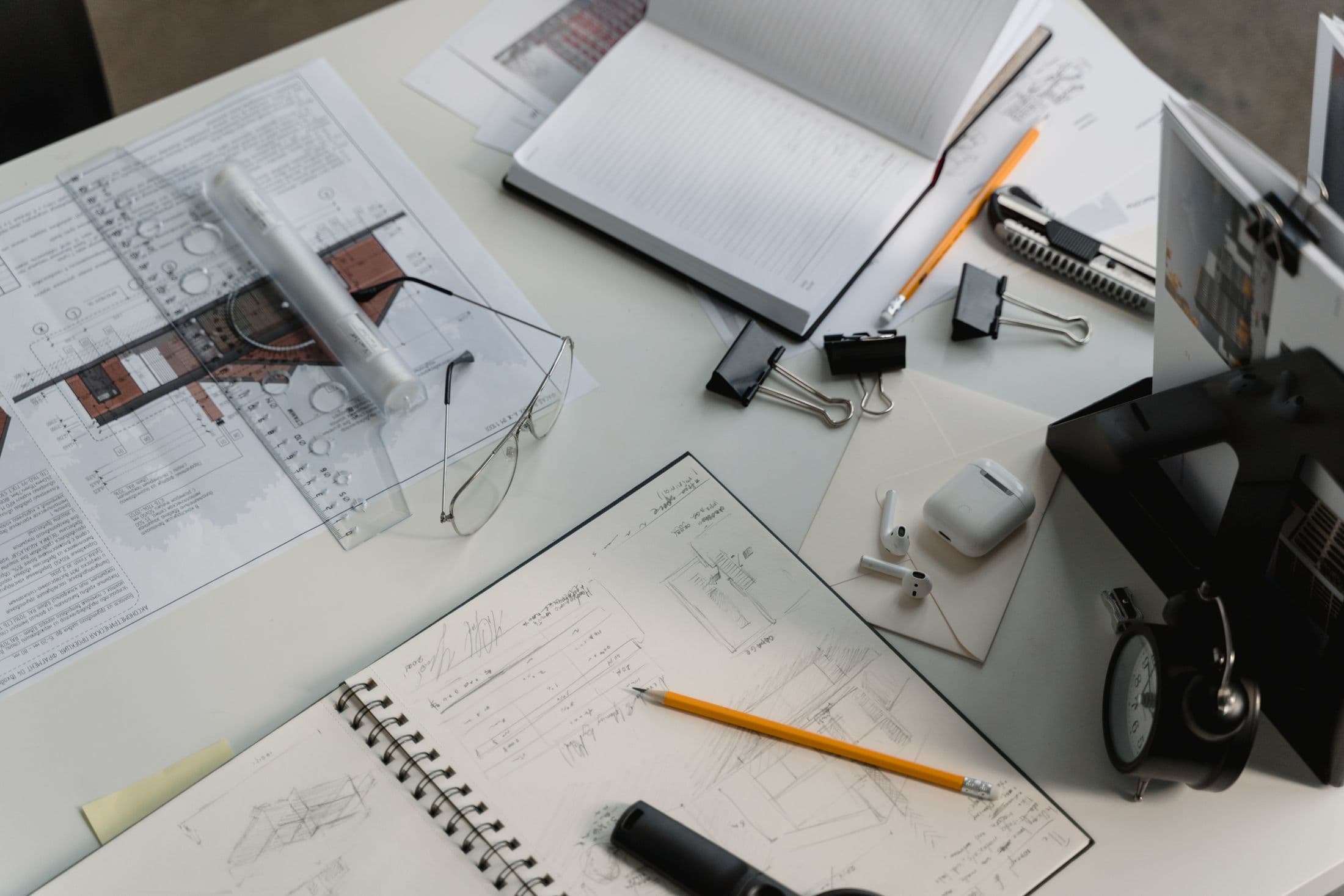 Architectural drawings, sketches and instruments on a professional desk