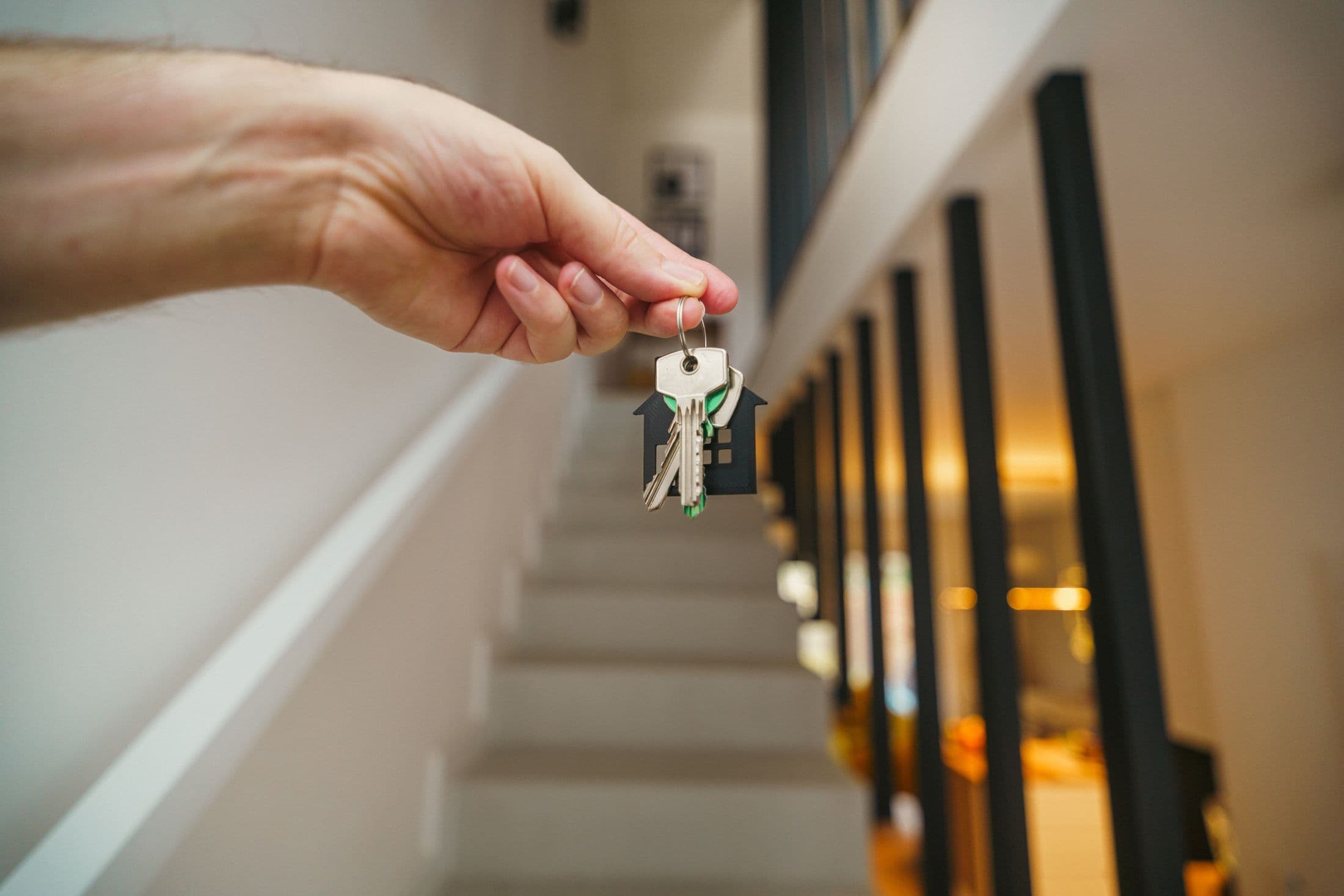 House keys held inside a completed contemporary property